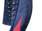 an image of a blue military jacket with red trims