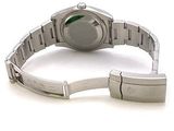 a watch that is sitting on a bracelet on a white surface