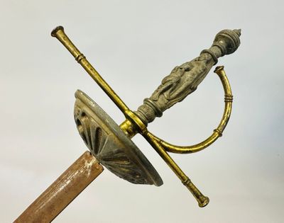 a gold colored sword with a handle and a wooden handle