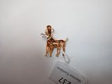 a gold dog charm on a white background with a price tag