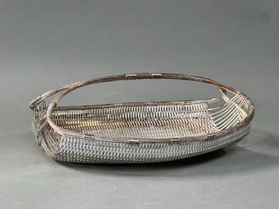 an image of a basket with a handle on a gray surface