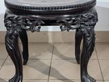 a black table with a marble top on a tiled floor