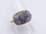an image of a ring with a blue and purple stone in it