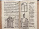 an open book with a drawing of a building on it