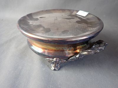 a silver plate with a turtle on it sitting on a table