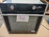 an oven sitting on top of a cardboard box with a price tag on it