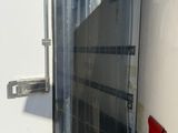 a white trailer with a red door in the back of it