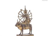 brass statue of a man riding a bull with a woman on its back