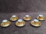 six cups and saucers are sitting on a table
