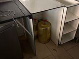 a kitchen with a sink and a refrigerator in it