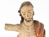 a statue of jesus holding a cross on a white background