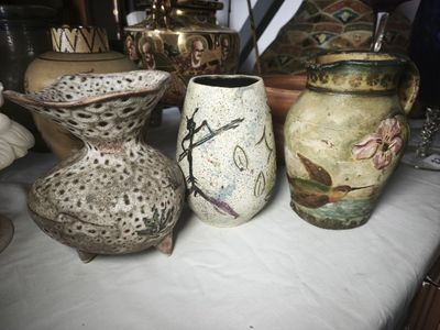 three vases sitting on a table next to each other