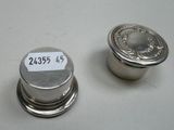 two silver metal knobs with numbers on them sitting on a table