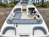 a white and gray boat sitting in the middle of the woods