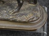 a statue of a dog that is sitting on top of a table