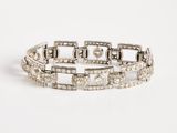 a white gold bracelet with diamonds on a white background