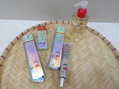 three bottles of lotion sitting on top of a bamboo tray