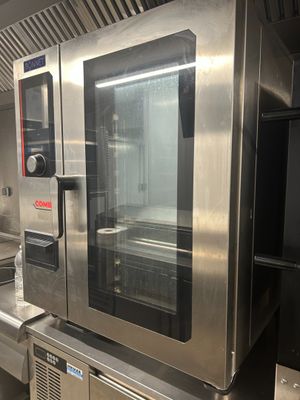 a large stainless steel oven sitting in the middle of a kitchen