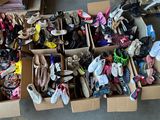 many pairs of shoes in a box on the floor