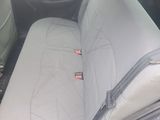 the back seat of a car with a seat cushion in it