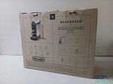 packaging of a nespresso coffee maker sitting on a table