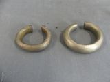 pair of antique brass hoop earrings on a gray surface