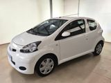 a picture of a small white car parked in a garage
