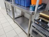 a kitchen with a stove, oven, and a shelf with bins on it