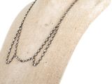 silver beaded necklace on mannequin display on white background