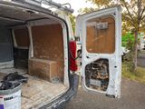 a white van that has been vandalized and is parked on the side of the road