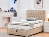 the bed is made and has a mattress on top of it