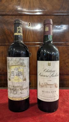 two bottles of wine sitting next to each other on a table