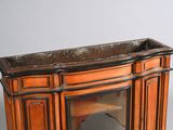 a small wooden cabinet with a mirror on top of it