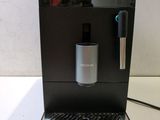 an image of a coffee machine sitting on top of a white table