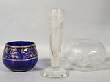 a blue vase and a glass sitting next to each other