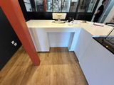 a white desk with a computer on it in a room