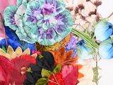 many different colored flowers in a vase on the table