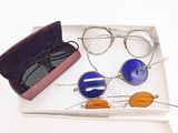 two pairs of glasses and a case on the table