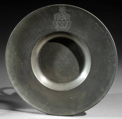 a silver plate with a design on it on a table