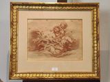 tableau représentant une femme tenant un enfant dans ses bras, posé sur un chevalet