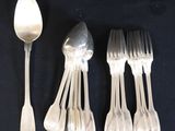 six silver spoons and six forks are lined up on a black surface