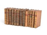 books are lined up in a row on a white surface