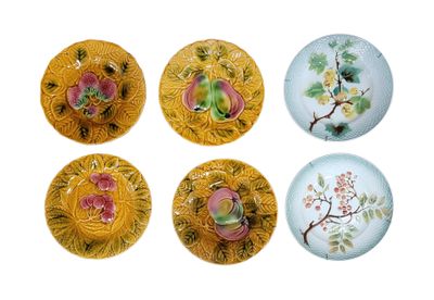 four plates with flowers and leaves painted on them on a white surface