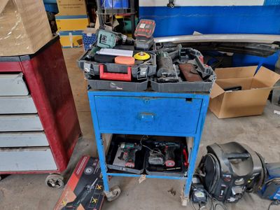 a blue workbench with tools on it in a garage