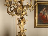 a gold candelab with five candles on a table