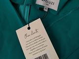 a close up of a label on a green shirt
