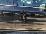 a black car with a fire hydrant on the side of the road