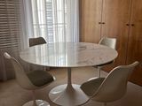 a marble table with four chairs around it