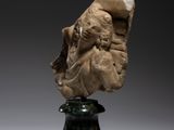 a marble head of a man on a pedestal