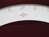 a close up of a white scale with a red background